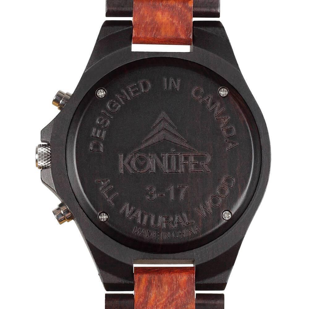 Montre en bois noir et rouge zebre a cadran rond. Vue arriere du cadran